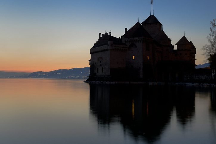 De nombreux monuments de Suisse, comme ici le château de Chillon, ont éteint leurs lumières pour le climat ces dernières années (archives). © KEYSTONE/JEAN-CHRISTOPHE BOTT